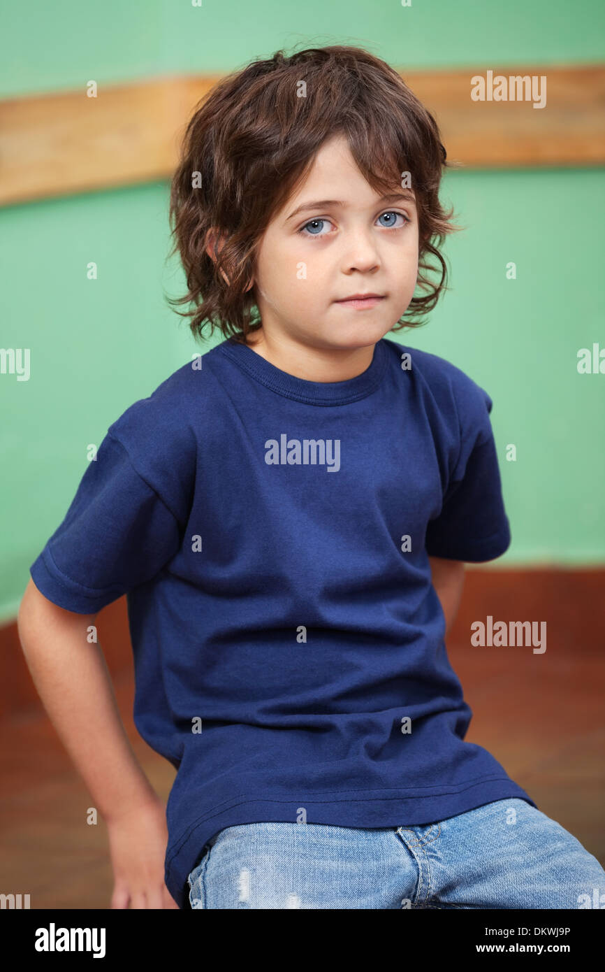 Cute Little Boy Sitting In Classroom Stock Photo - Alamy