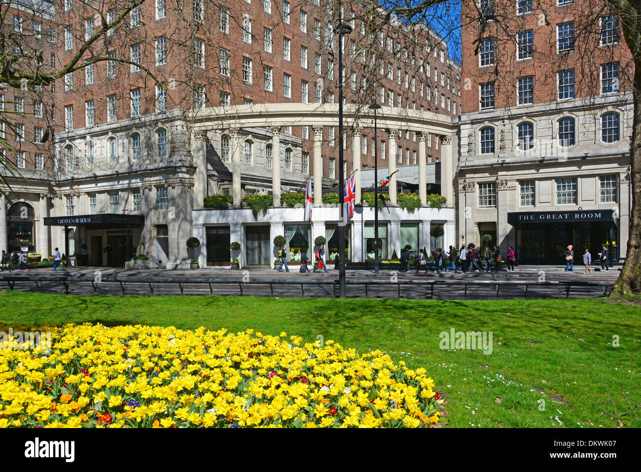 Grosvenor House Hotel buildings including entrance to The Great Room with spring flowers in Park Lane Stock Photo