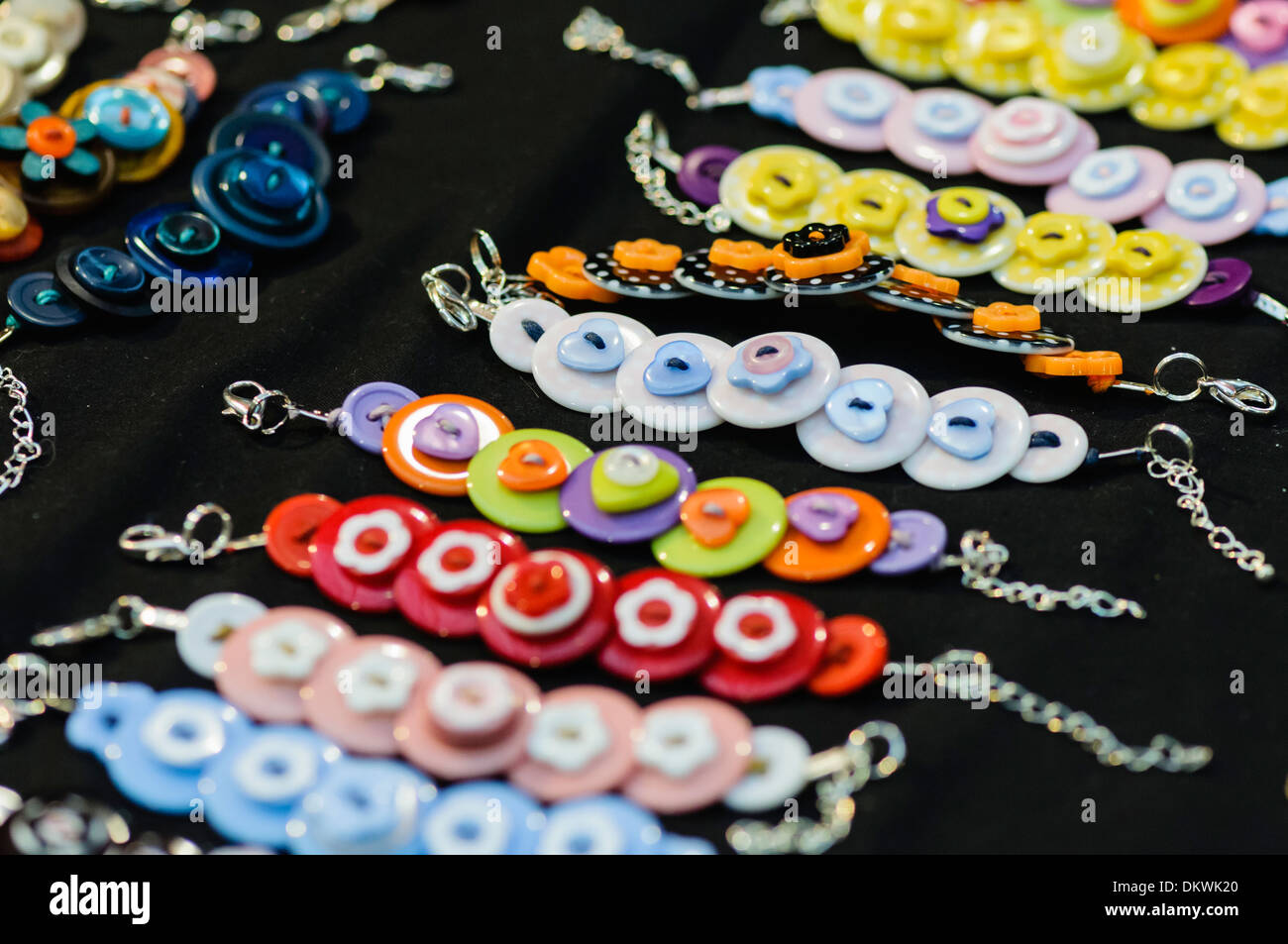 Jewelery made from buttons on sale at a market stall Stock Photo