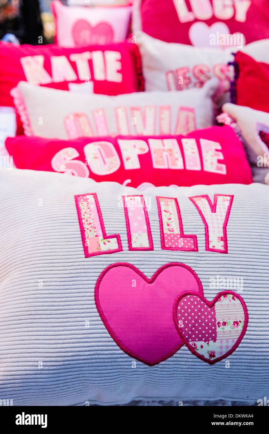 Cushions with girls names on sale at a market stall Stock Photo