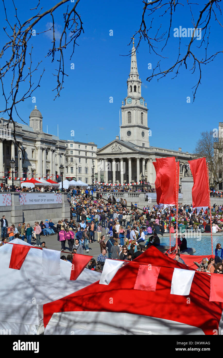 Red & white bunting at Mayor of London Feast of St George event & celebrations crowd of people blue sky spring day Trafalgar Square London England UK Stock Photo