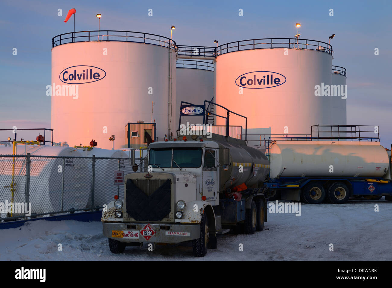 Red glow on gas tanks and tanker trucks at sunrise in Deadhorse Alaska USA Stock Photo
