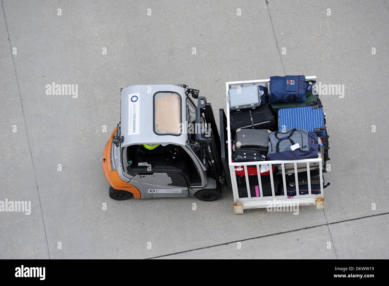 A forklift truck transporting suitcases. Stock Photo