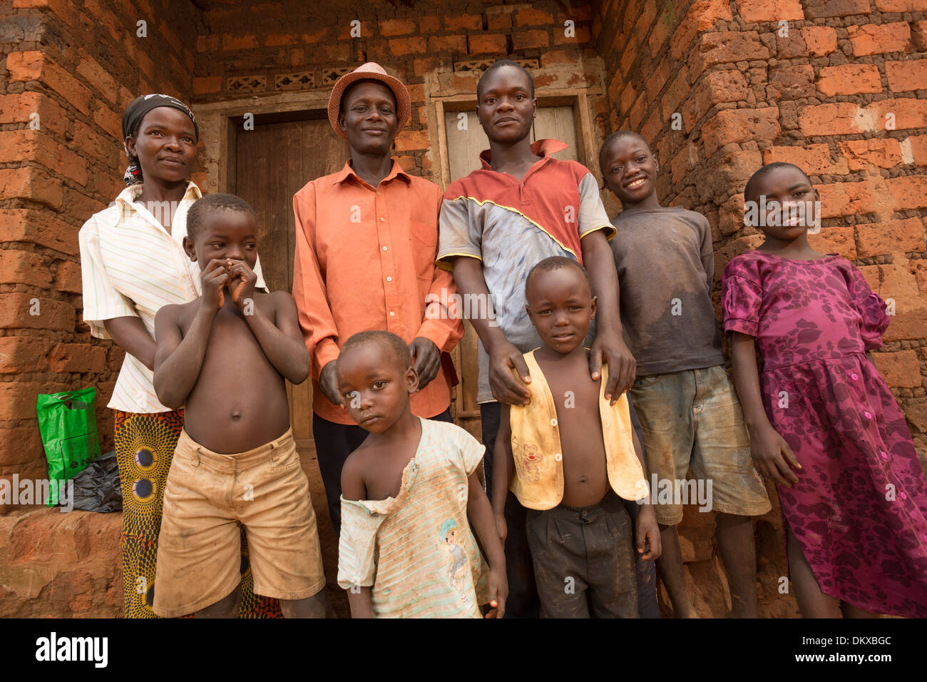 An large family stands outside their home in Gombe, Uganda, East Africa. Stock Photo