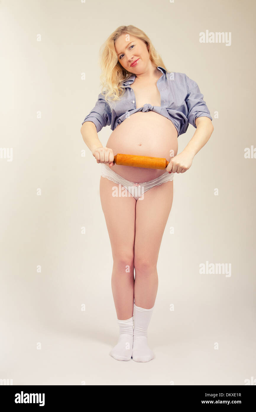 fun pregnant woman with rolling pin Stock Photo - Alamy
