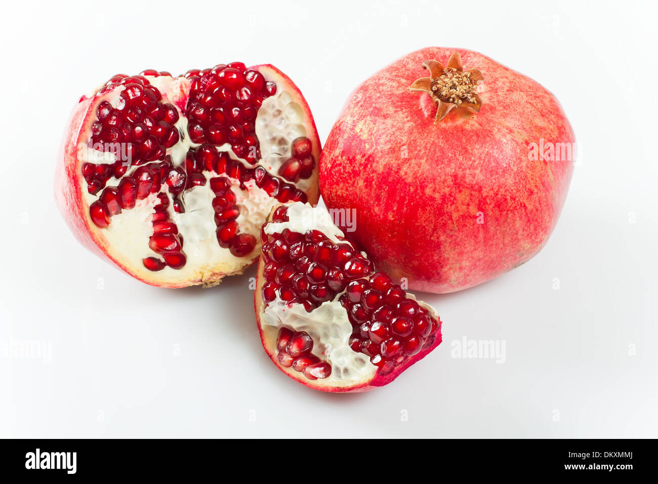 pomegranate fruit with cut, leaves and flower Stock Photo
