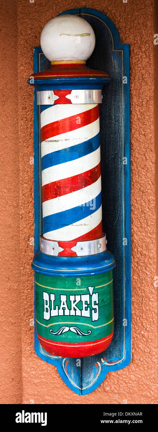 Old fashioned barber's pole outside a barber shop on First Street in historic downtown Fort Myers, Florida, USA Stock Photo