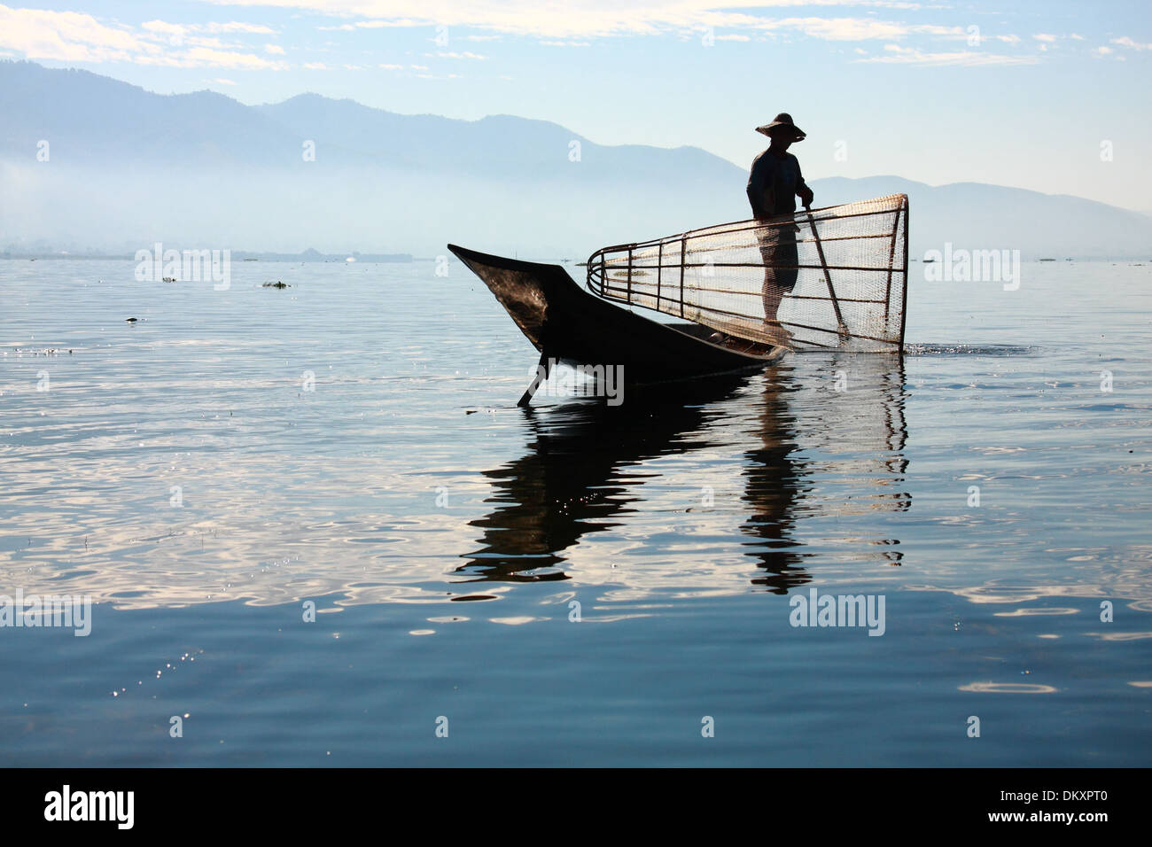Intha people possess the leg-rowing style and the unique coop-like fishing equipment Stock Photo