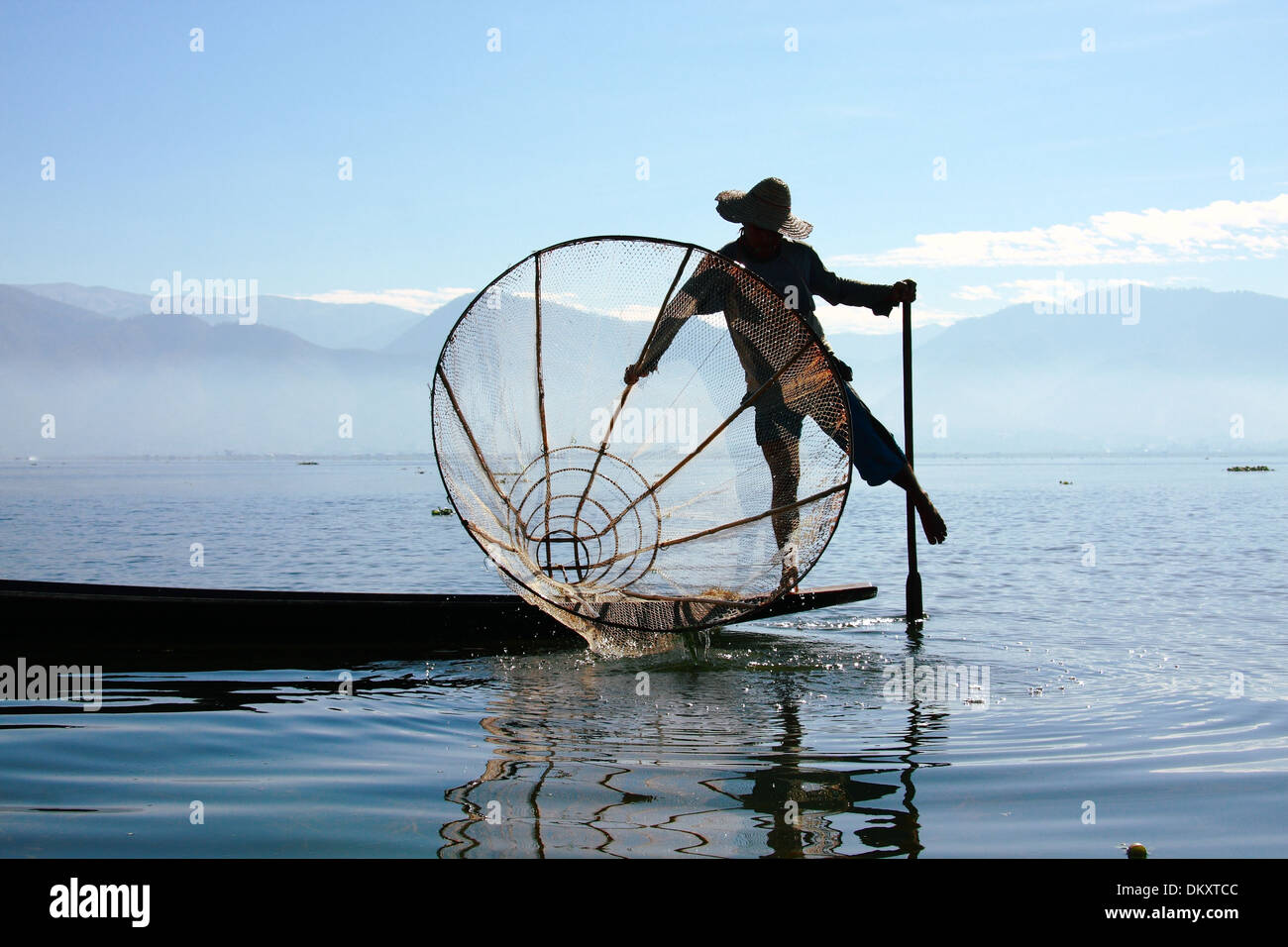 Intha people possess the leg-rowing style and the unique coop-like fishing equipment Stock Photo