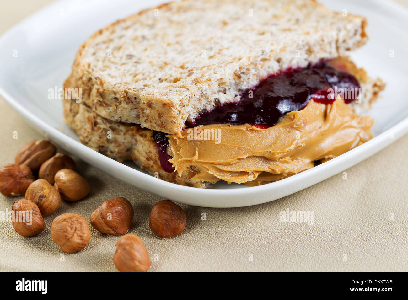 Closeup horizontal photo of a peanut butter and jelly sandwich cut in