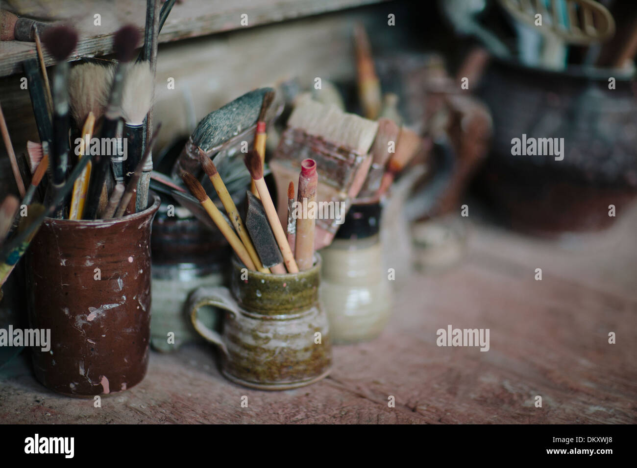 Paint Brushes in pottery mugs Stock Photo Alamy