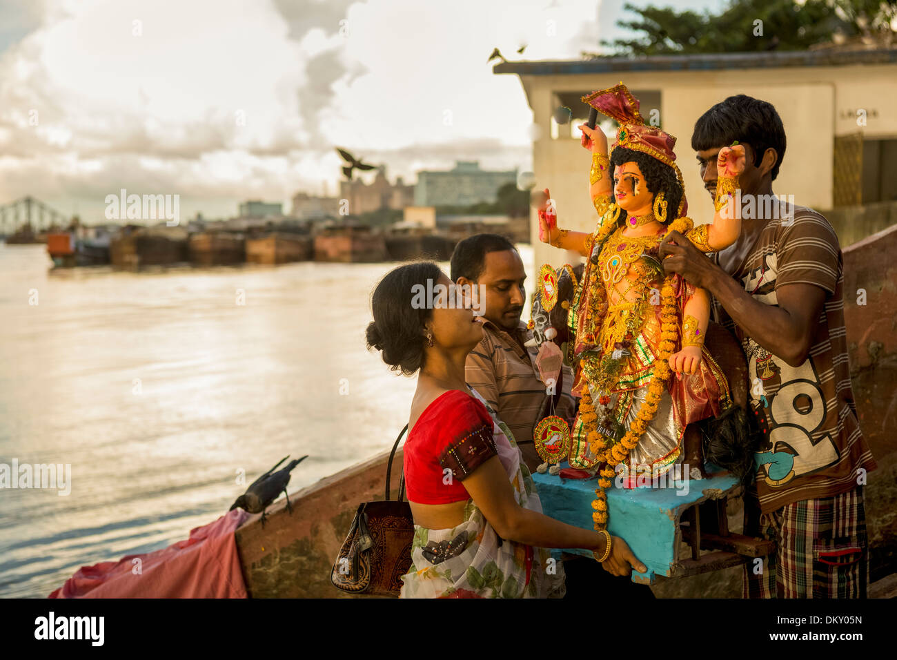 Celebrants bring a statue of a god to the waters of the Hooghly River during Vishwakarm Day in Calcutta (Kolkata), India. Stock Photo