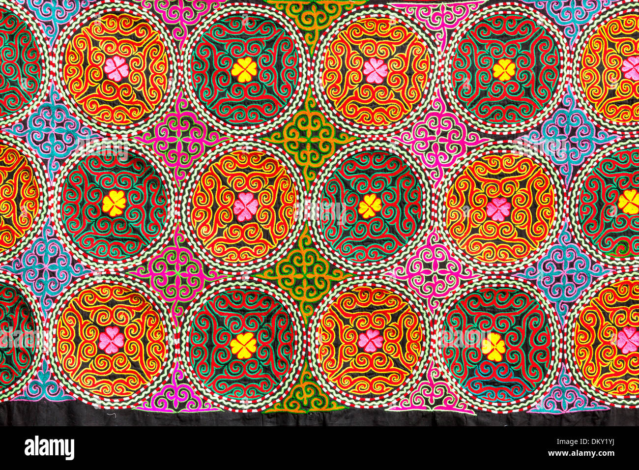 Colourful Suzani textile, cotton hand embroidered needlework, for sale, Bukhara, Uzbekistan Stock Photo