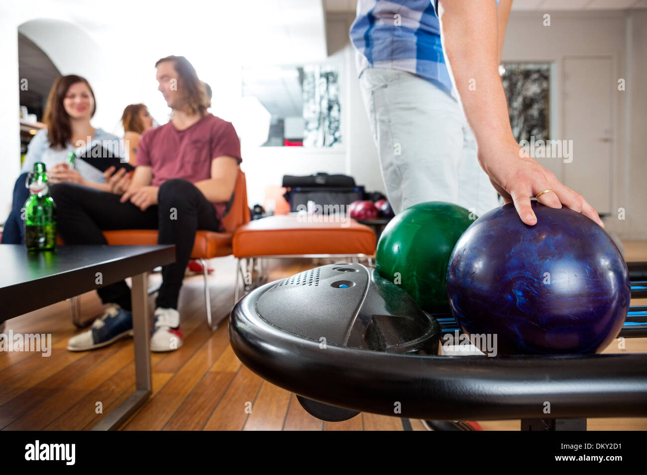 Man Picking Bowling Ball From Rack Stock Photo Alamy