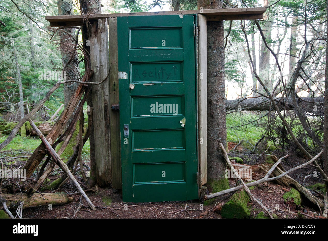 Mysterious green door resides along forest path on the uninhabited, but privately owned, island of Buckle, Maine Stock Photo