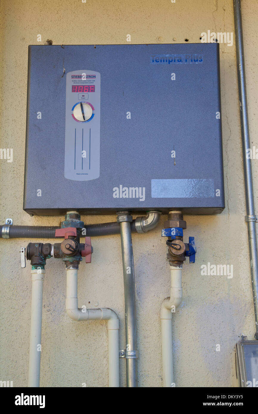 Tankless water heater on side of Green home that is off the grid. Los Angeles, California, USA Stock Photo