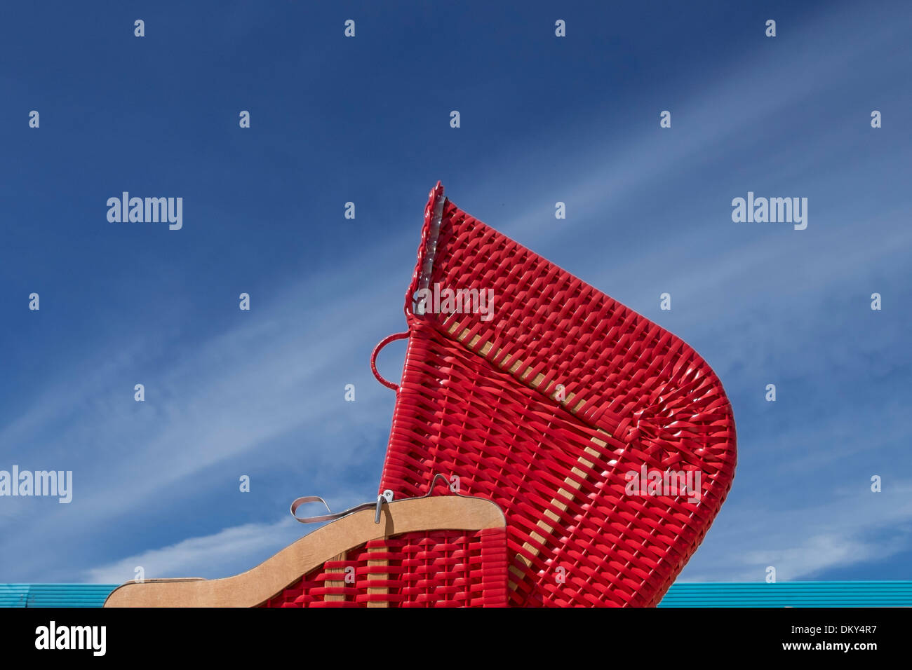 Red beach chair in front of blue sky, beach club, Hamburg Germany Stock Photo