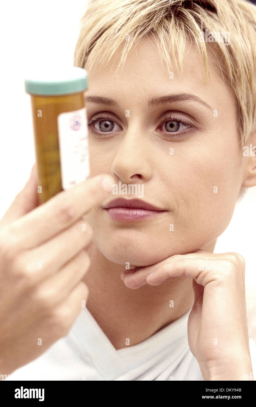 WOMAN READING LABEL ON MEDICATION PRESCRIPTION TABLET Stock Photo Alamy