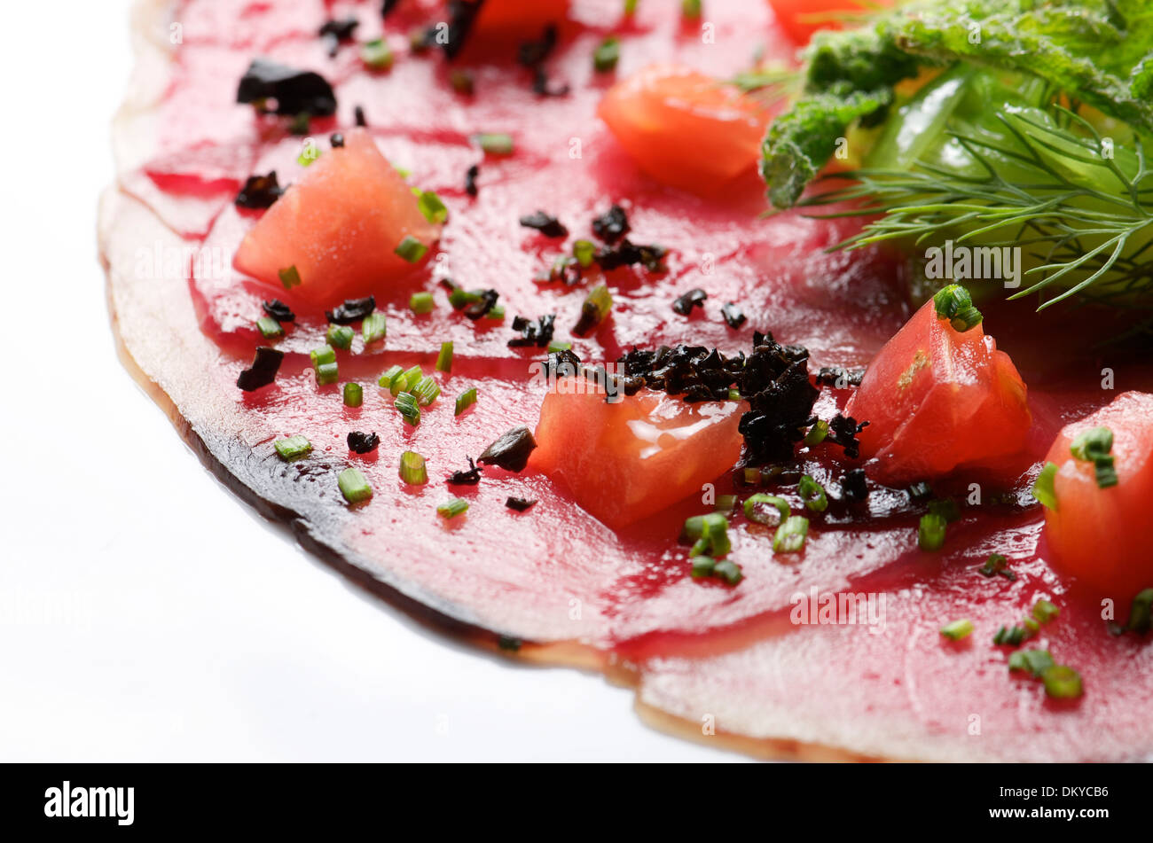 forefront of carpaccio of tuna with diced tomatoes Stock Photo Alamy