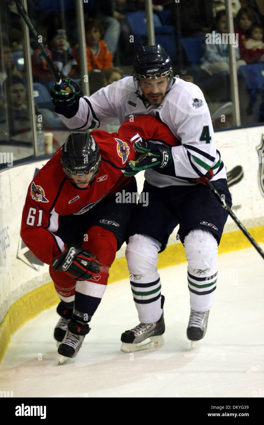 Nov. 25, 2009 - Plymouth, Michigan, U.S - 25 November 2009: Windsor Spitfire forward Austin Watson (61) and Plymouth Whaler defenseman Leo Jenner (4) fight for position behind the net. The Windsor Spitfires defeated the Plymouth Whalers 2-1 in a game played at Compuware Arena in Plymouth, Michigan. (Credit Image: © Alan Ashley/Southcreek Global/ZUMApress.com) Stock Photo