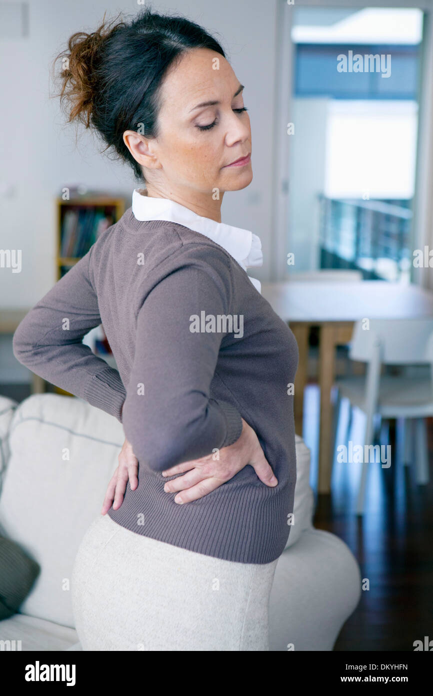 LOWER BACK PAIN IN A WOMAN Stock Photo