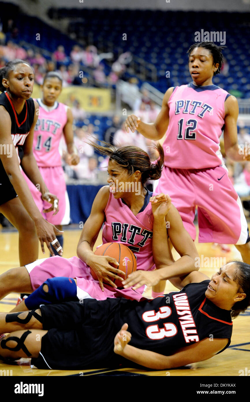 Feb. 14, 2010 - Pittsburgh, PA, U.S - 14 February 2010: University of Pittsburgh junior guard Shayla Scott (25) gets taken down by University of Louisville sophomore forward Monique Reid (33) as they were going for a rebound in the second half of NCAA women's Big East basketball action at the Petersen Events Center in Pittsburgh, PA...The Pitt Panthers players are wearing pink unif Stock Photo