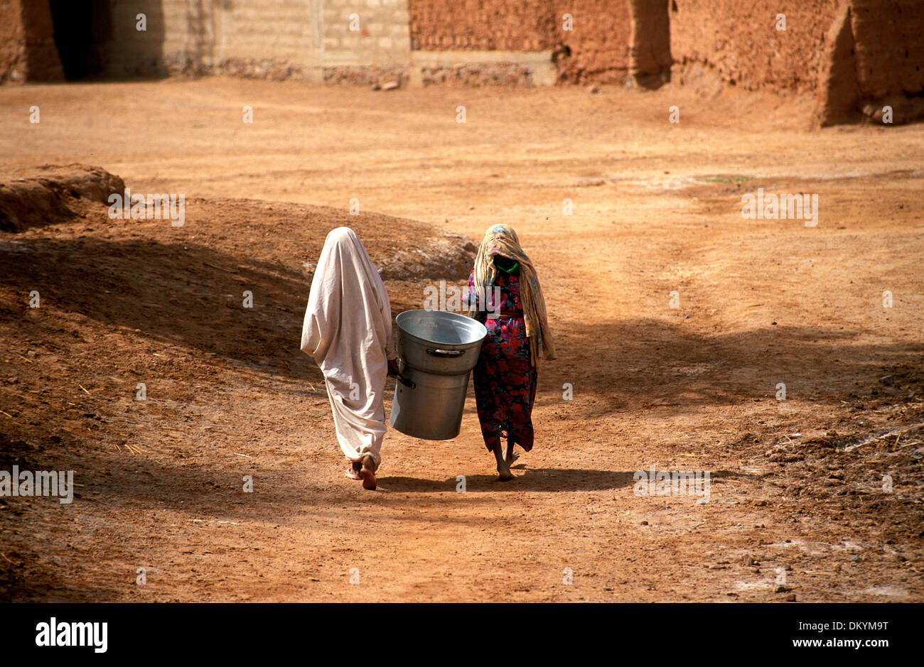 Tuareg population of Timimoun in Algeria. Two women walking home from the market. Stock Photo