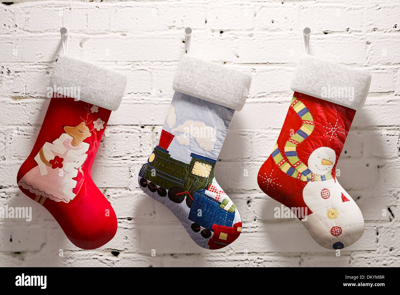 Christmas socks hanging on a white brick wall Stock Photo Alamy