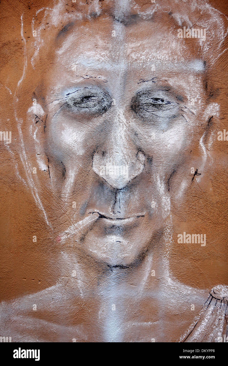 Illustration with chalk on a wall of Julius Caesar smoking a cigarette. Stock Photo