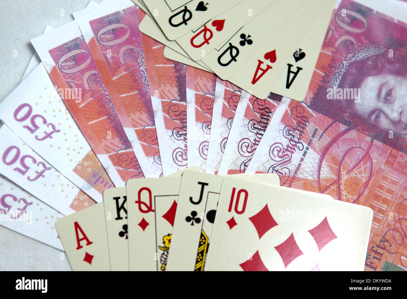 Playing cards and money in casino. Stock Photo