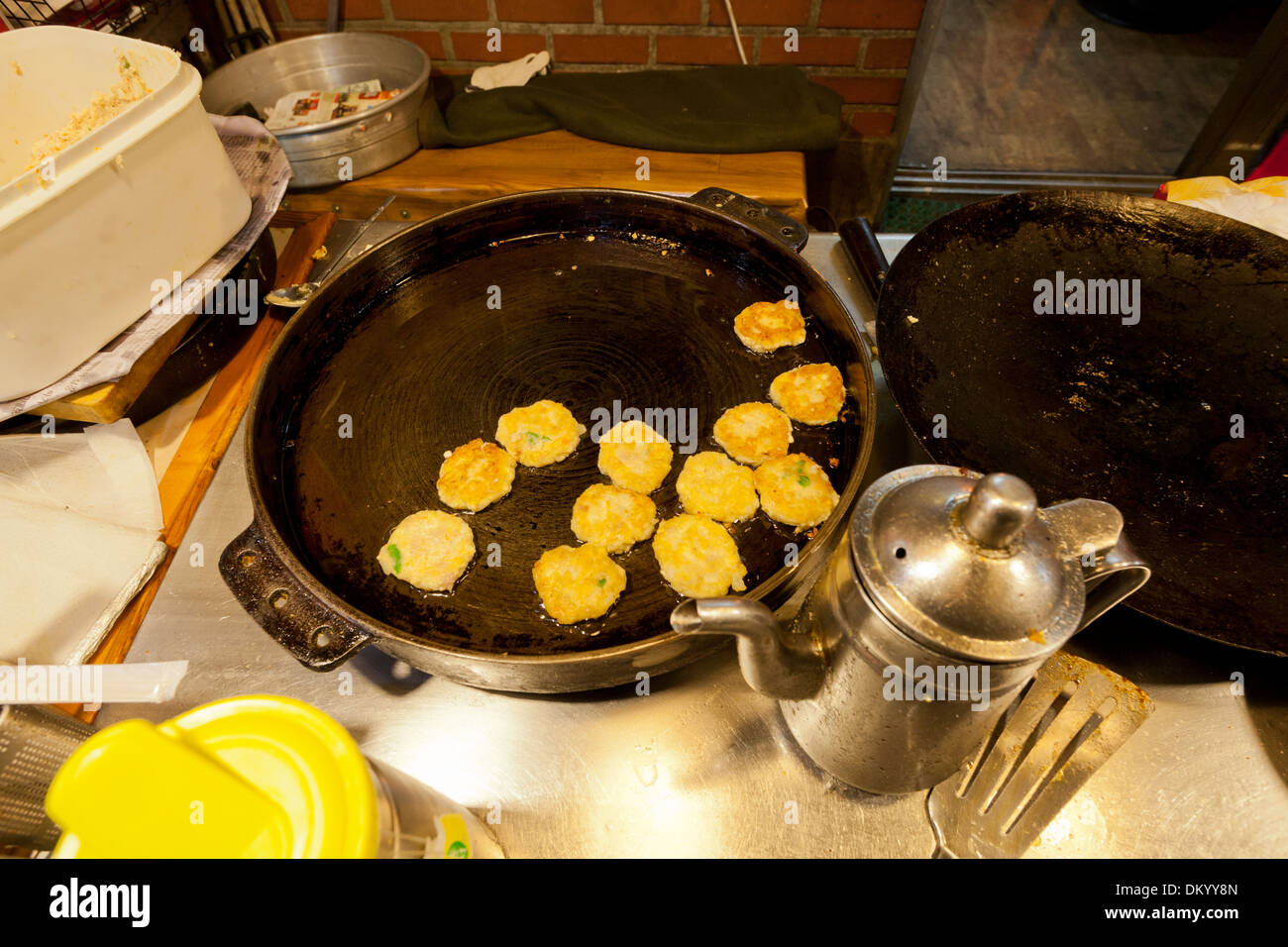 Minced meat patties (Jeon) grilling on cast iron pan - South Korea Stock Photo