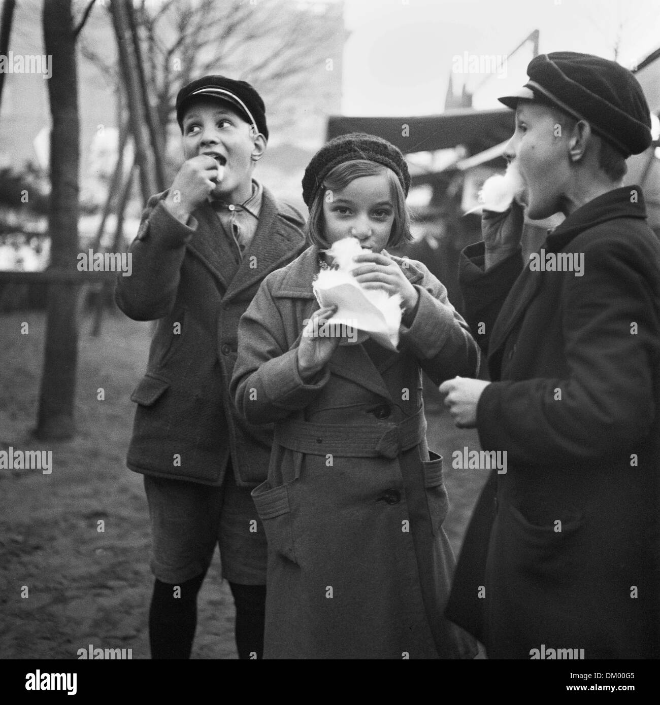 Children eat cotton candy on a Christmas market in Berlin, Germany