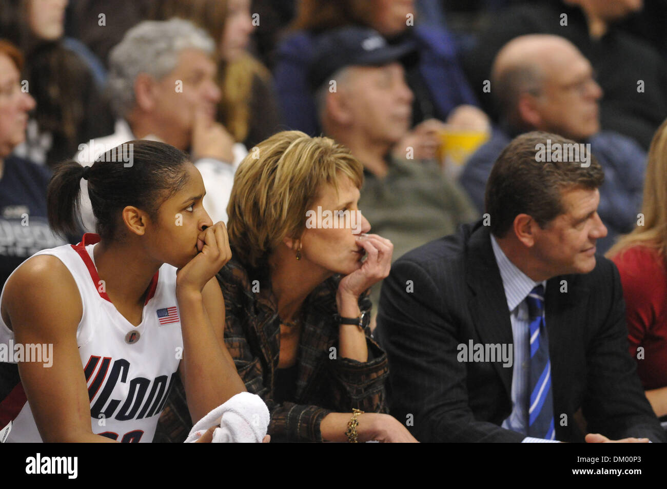 Connecticut associate head coach Chris Dailey does her best, in vain, to  keep head coach Geno Auriemma from picking up a technical foul from  official Joseph Vaszily late in the first half