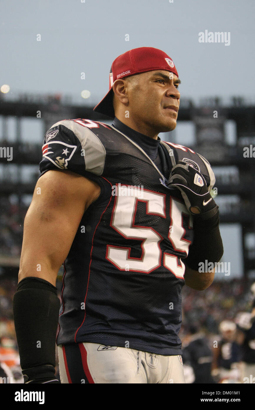 New England Patriots linebacker Junior Seau (55) hoists the AFC Championship  Lamar Hunt trophy after the team defeated the San Diego Chargers 21-12 in  the AFC Championship game at Gillette Stadium in