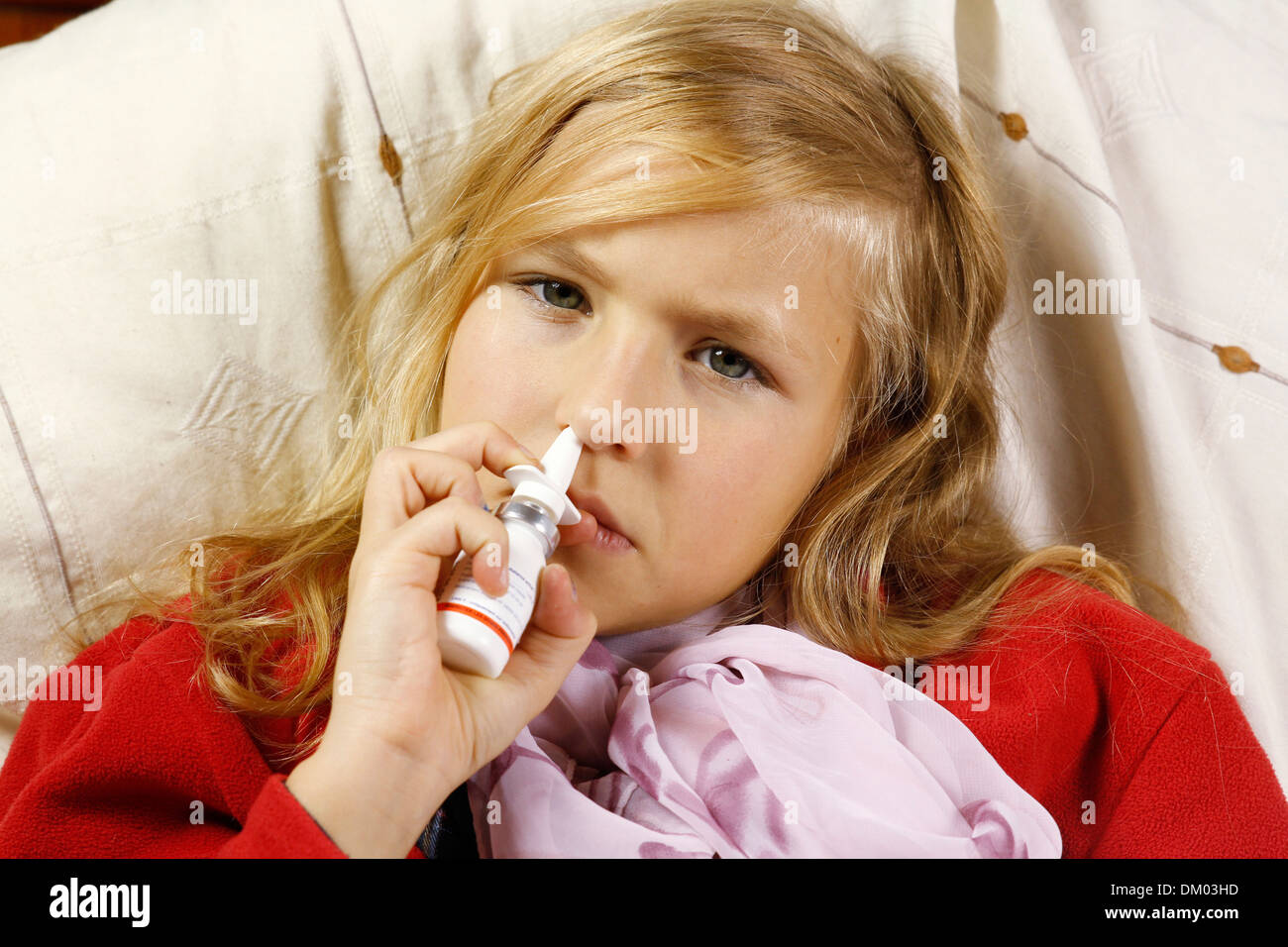CHILD USING NOSE SPRAY Stock Photo