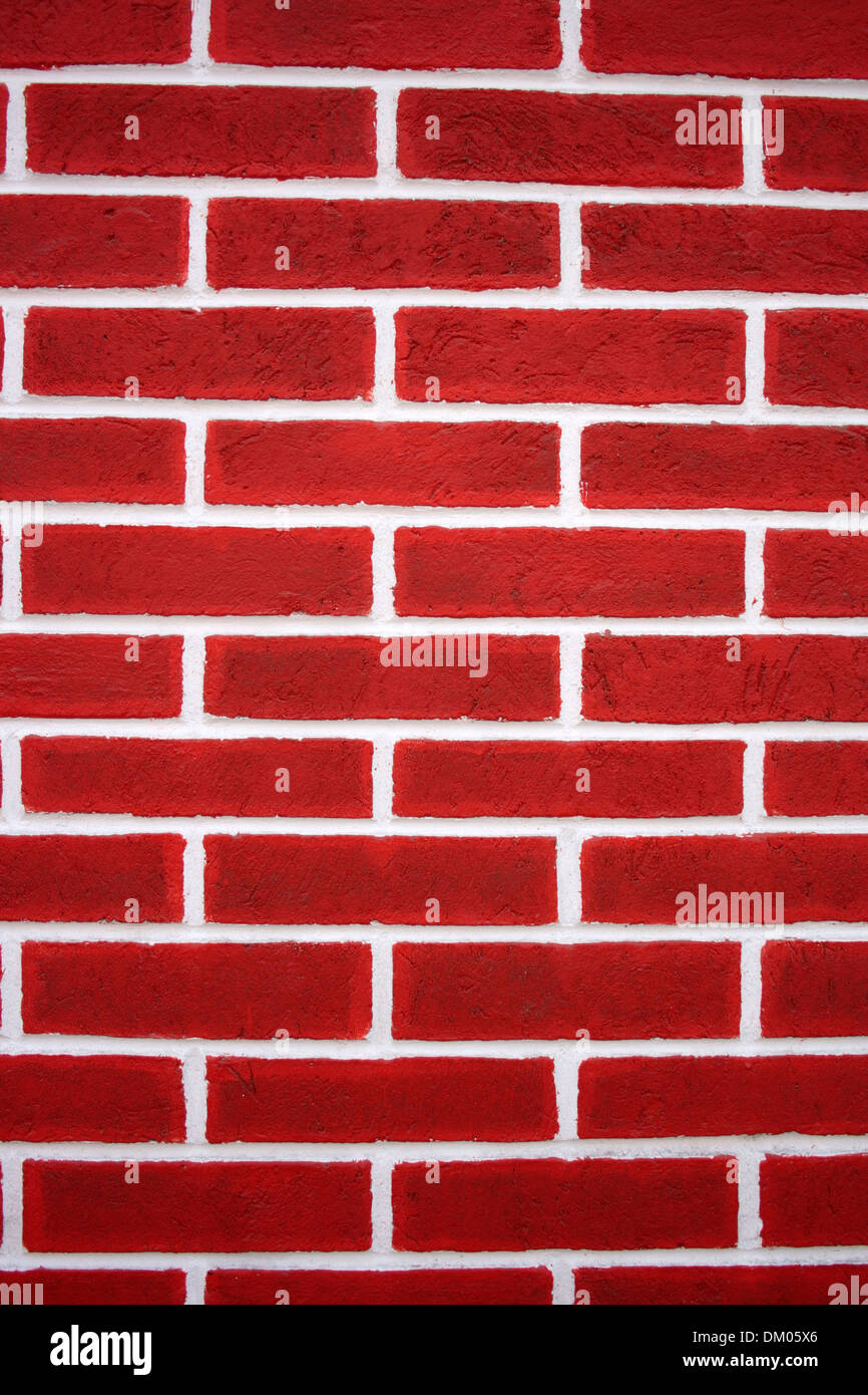 A red brick wall with white mortar in a wall in Cotacachi, Ecuador Stock Photo