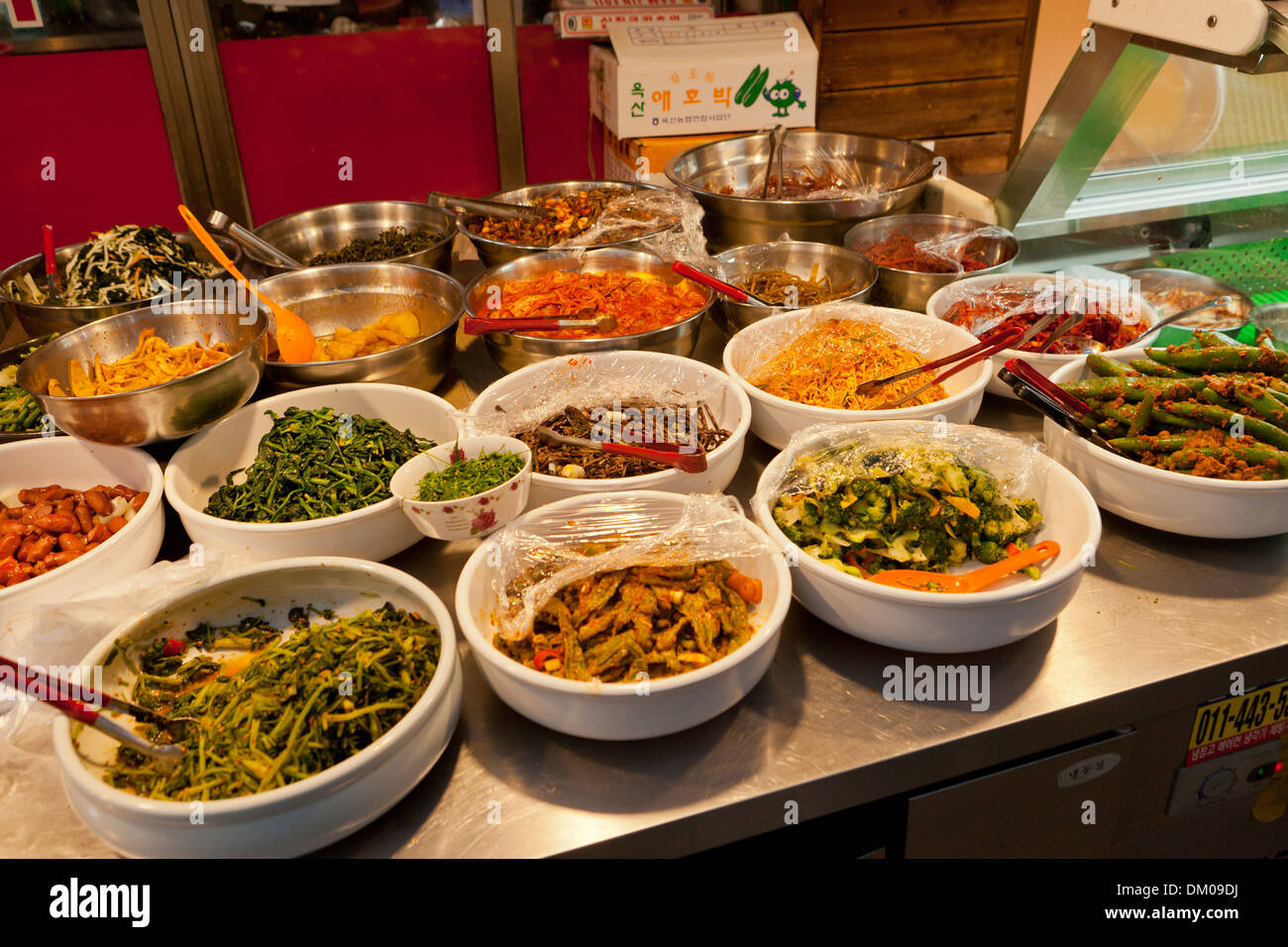Kimchi and other Korean side dishes displayed for sale at traditional market - Seoul, South Korea Stock Photo