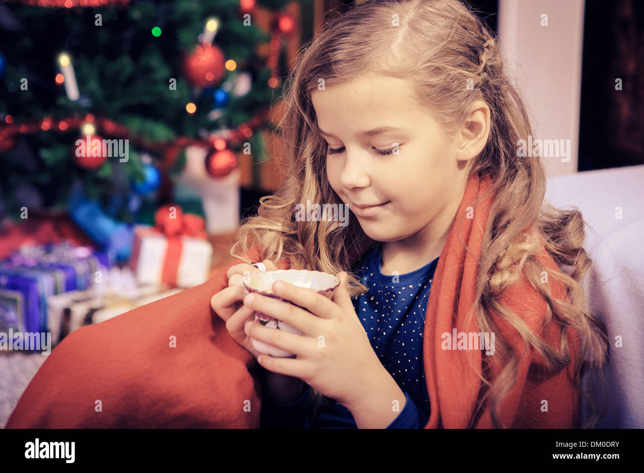 little girl drinking tea with xmas cookies at home Stock Photo
