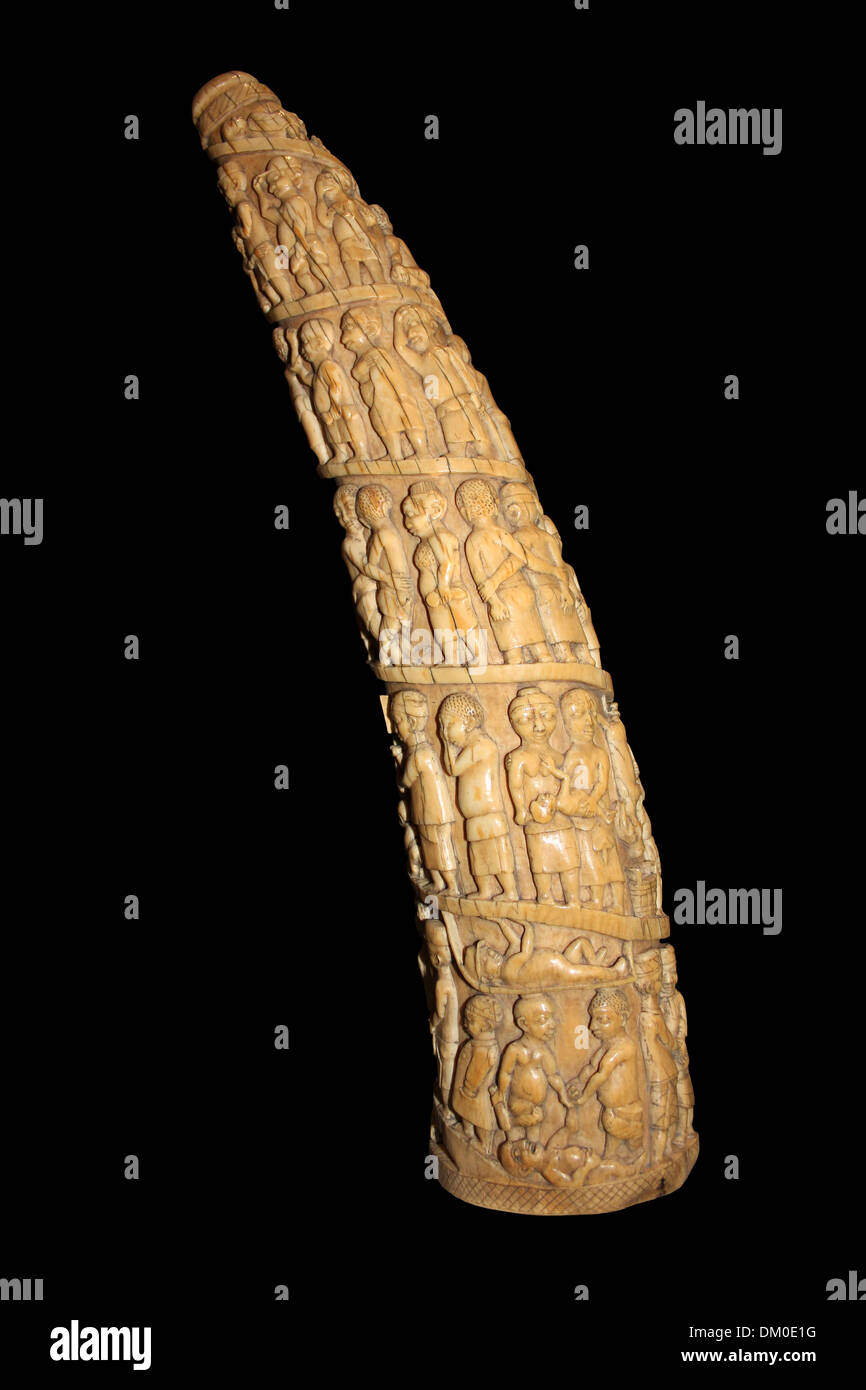 Carved Elephant Tusk Depicting Slaves Working For Europeans, Gabon, Central Africa Stock Photo