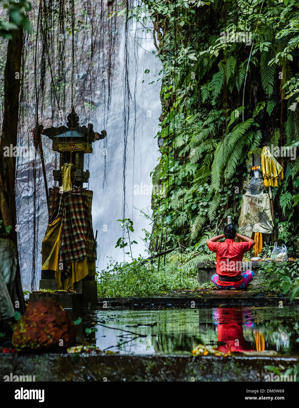 Hindu worshiper at waterfall in Tejakula, Bali Indonesia Stock Photo