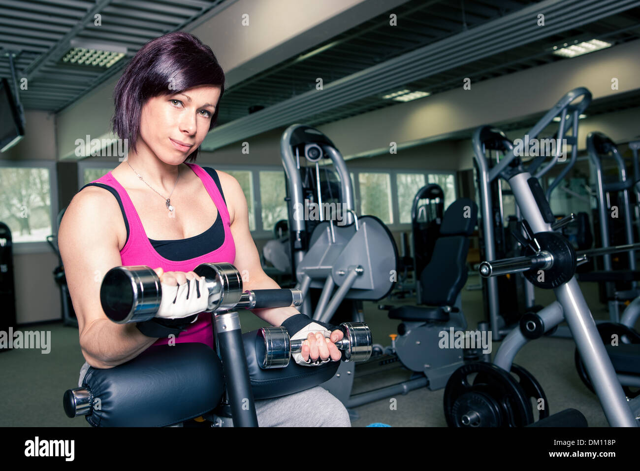young woman in sport dress in a gym room Stock Photo