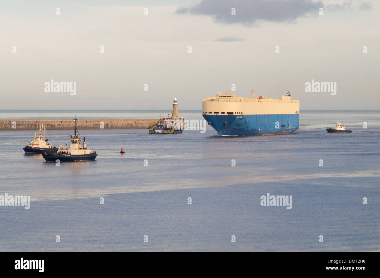 Car carrier Grand Phoenix entering the river Tyne accompanied by tugs South Shields north east England, UK Stock Photo