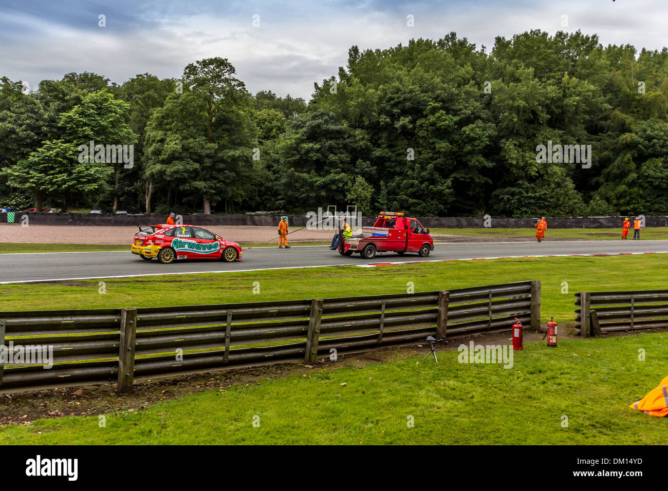 Racing car being towed and rescued by breakdown truck at car racing Stock Photo