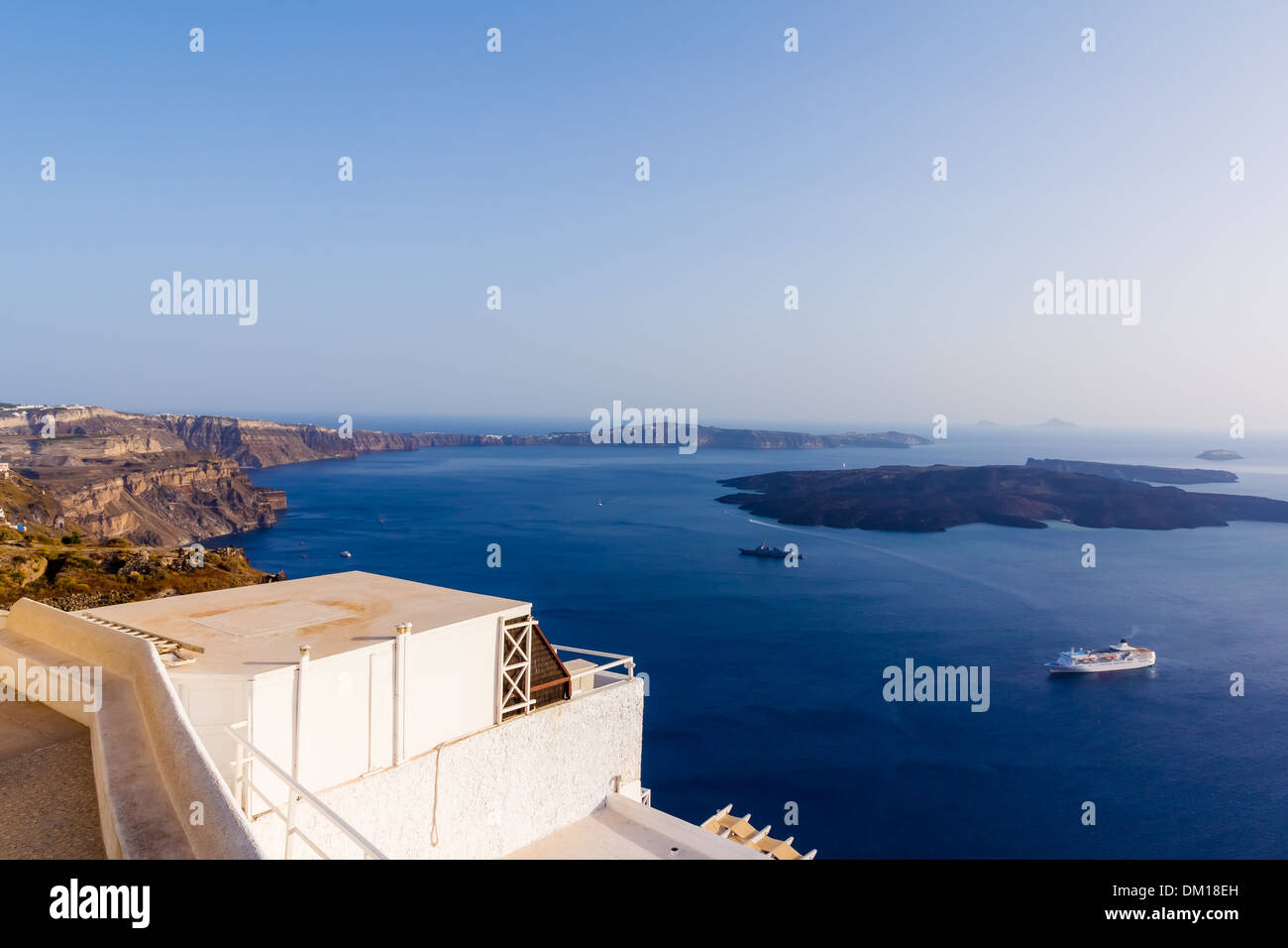 Nea Kameni volcanic island in Santorini Greece with ships in front photographed from a high point of view Stock Photo