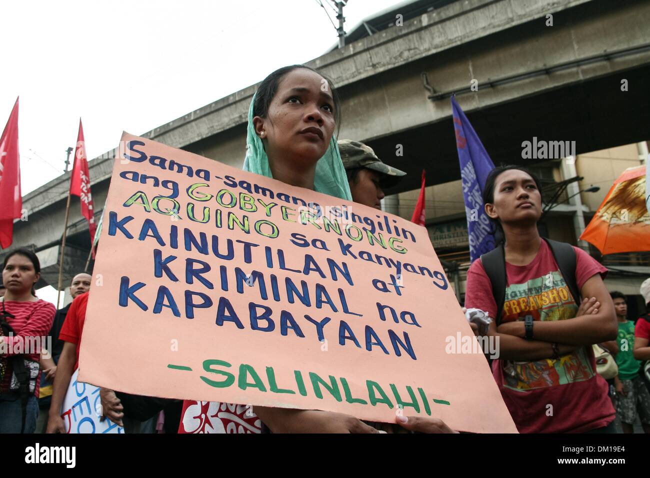 Manila, Philippines. 10th Dec, 2013. Sanlinlahi member holding a poster condemning President Aquino III's alleged incompetence over the country's current situation. -- Protesters commemorated the International Human Rights Day with a march to Mendiola, Manila bringing effigies of President Aquino III. They dubbed Aquino as the ''impunity king'' for alleged human rights violations since he started his term.Photo: J Gerard Seguia/NurPhoto Credit:  J Gerard Seguia/NurPhoto/ZUMAPRESS.com/Alamy Live News Stock Photo