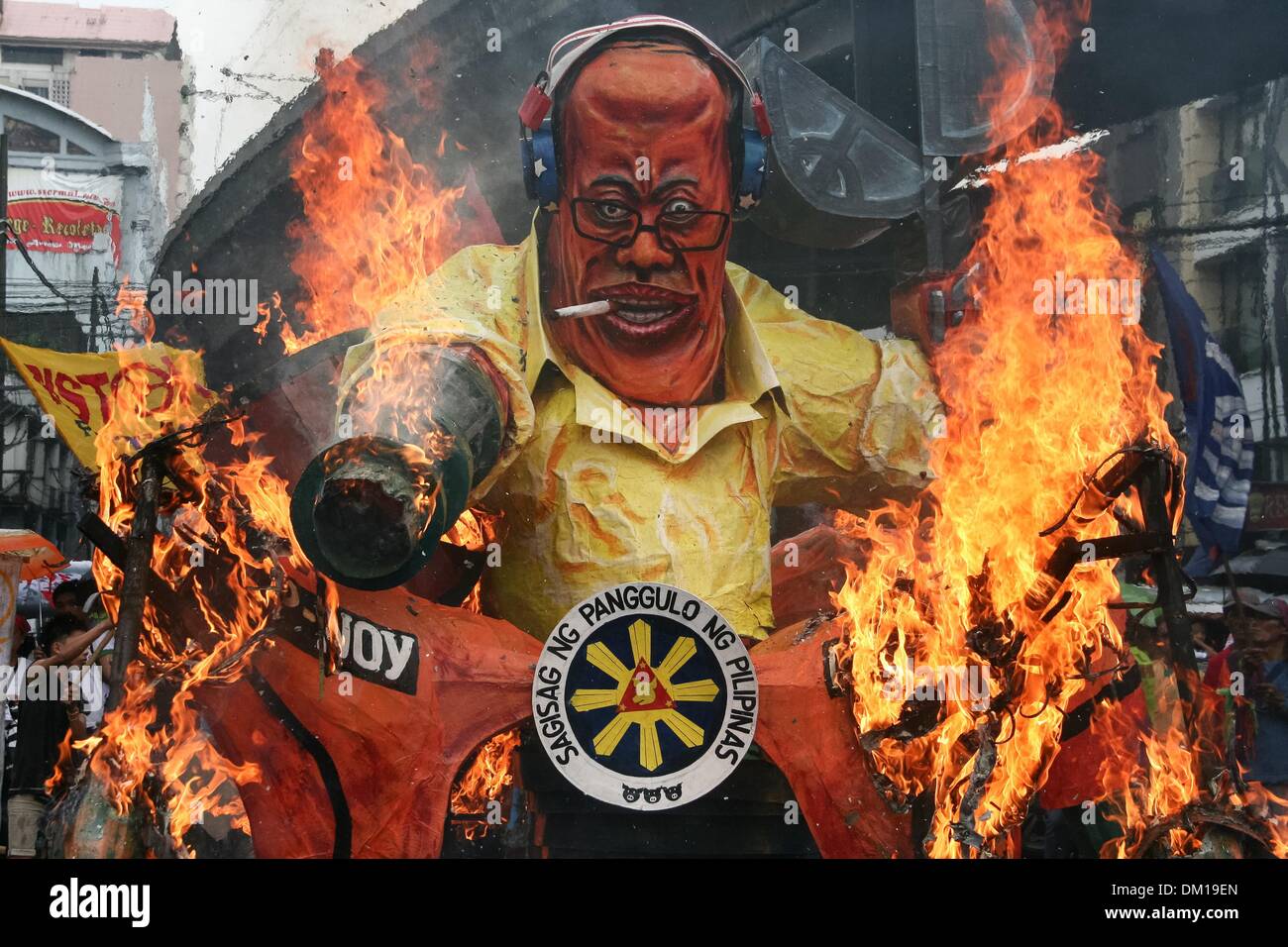 Manila, Philippines. 10th Dec, 2013. President Aquino III's effigy being burned in Mendiola, Manila. -- Protesters commemorated the International Human Rights Day with a march to Mendiola, Manila bringing effigies of President Aquino III. They dubbed Aquino as the ''impunity king'' for alleged human rights violations since he started his term.Photo: J Gerard Seguia/NurPhoto Credit:  J Gerard Seguia/NurPhoto/ZUMAPRESS.com/Alamy Live News Stock Photo