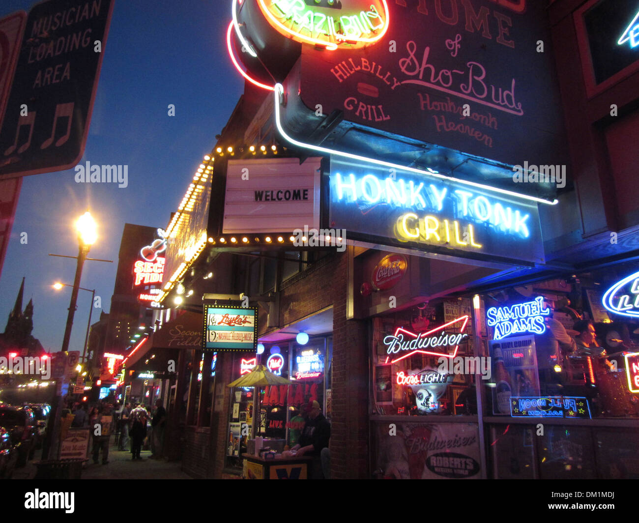 Exterior of Honky Tonk bars, lounges, and clubs and their neon signs on Broadway in downtown Nashville Tennessee. Stock Photo