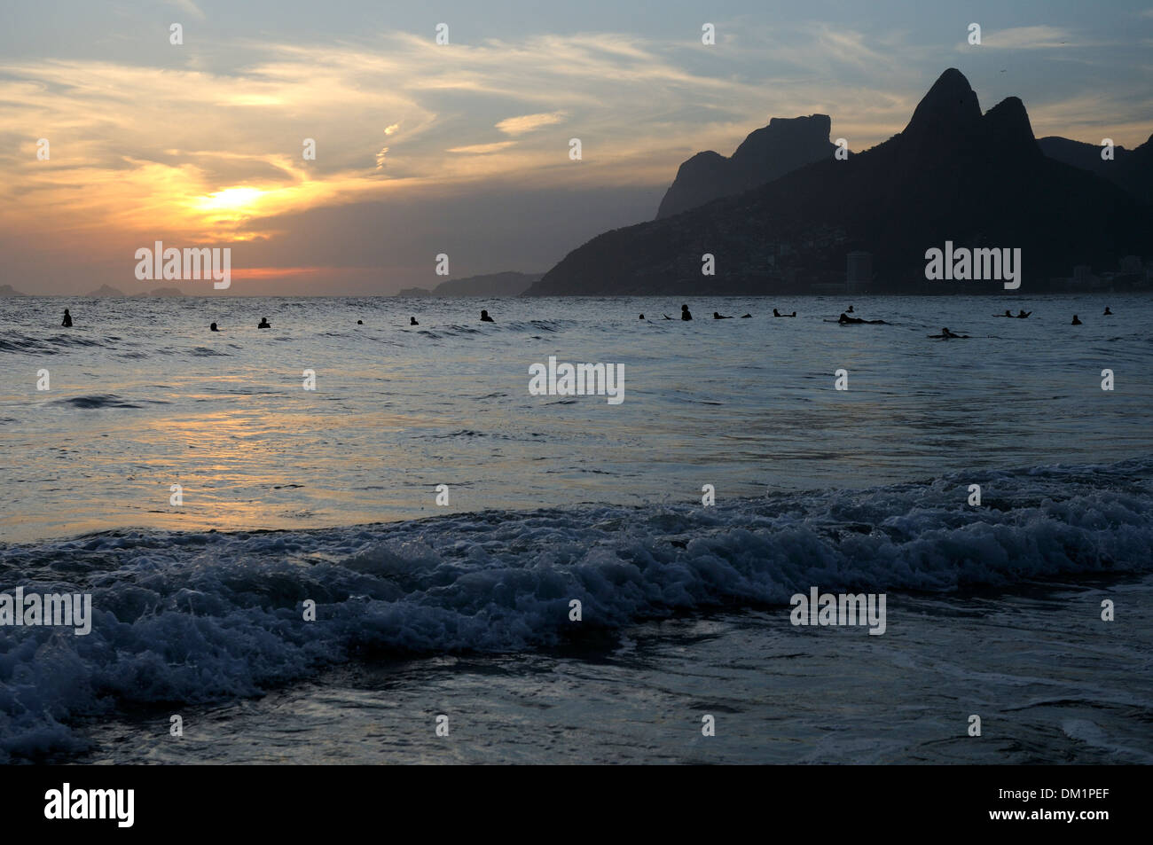 Surfers At Ipanema Beach At Sunset In Rio De Janeiro Brazil Stock surfers-at-ipanema-beach-at-sunset-in-rio-de-janeiro-brazil-stock