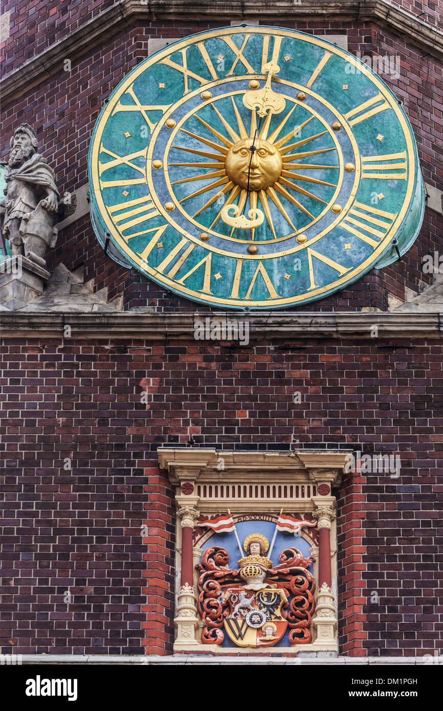The clock on teh side of the neo-Gothic Town Hall or Ratusz in Wroclaw's market Square. Stock Photo