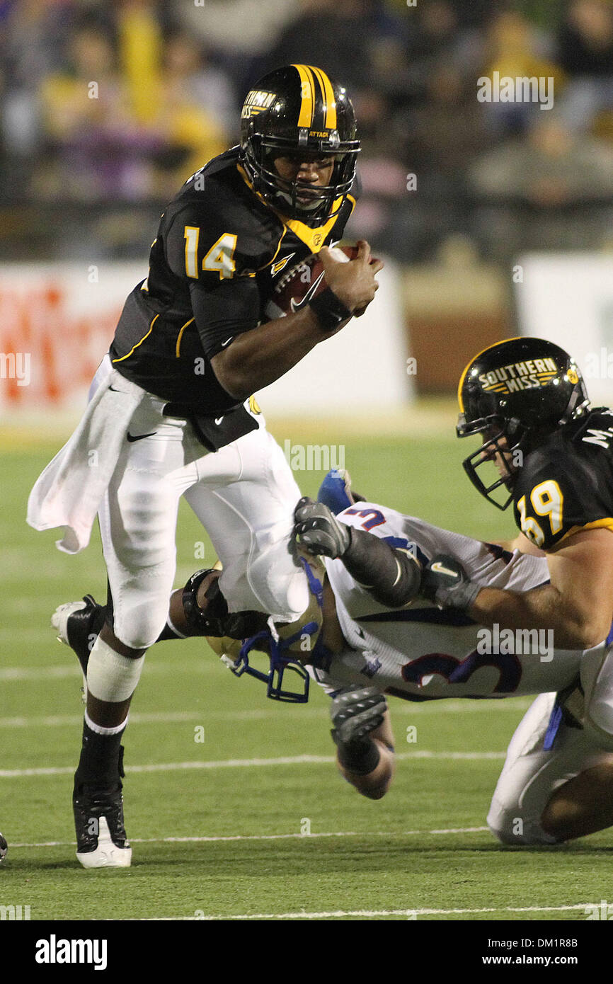 Southern Miss quarterback Martevious Young (14) breaks a tackle of